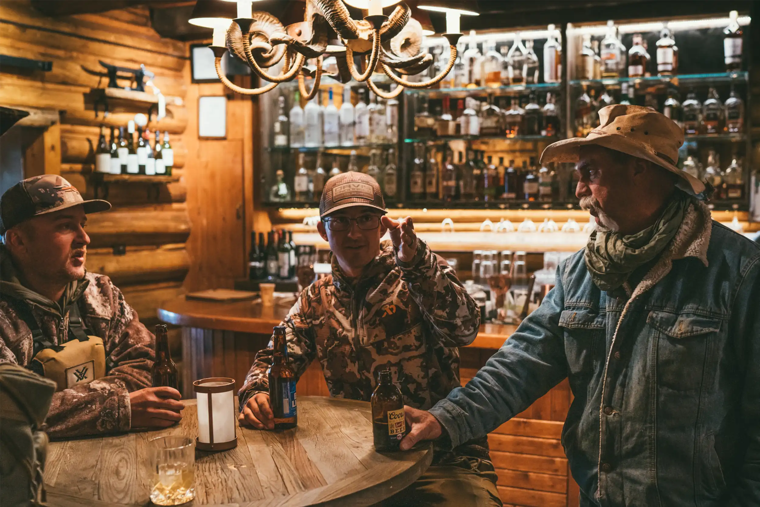 Hunters and guides gather in the bar for a toast after hunting all day